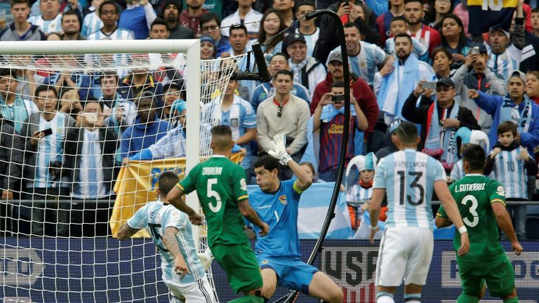 Argentina's Victor Cuesta (L) shoots to score against Bolivia as Bolivia's goalie Carlos Lampe gestures during the Copa America Centenario football tournam