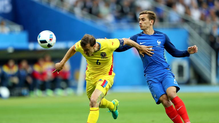 Romania's Vlad Chiriches and France's Antoine Griezmann battle for the ball 