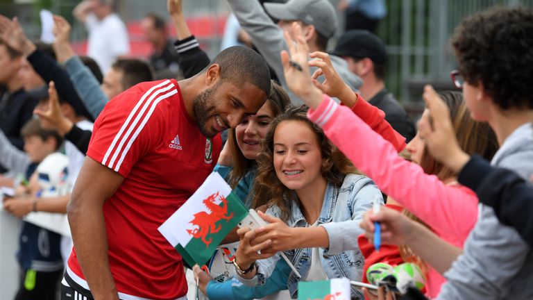 Wales captain Ashley Williams poses for pictures with local children after an open Euro 2016 Wales training session in Dinard