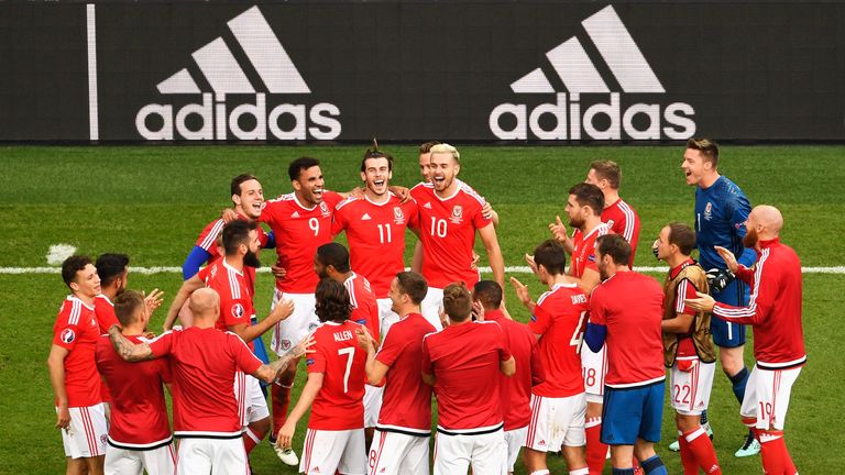 Wales players huddle to celebrate their 1-0 win over Northern Ireland