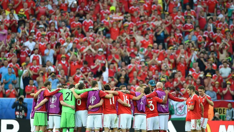 Wales' players huddle after beating Slovakia