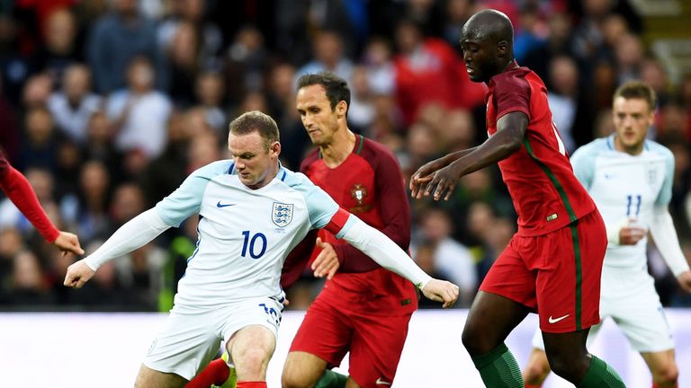 England skipper Wayne Rooney is surrounded by Portugal players