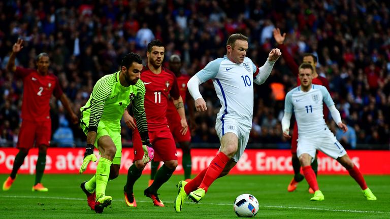 Wayne Rooney of England is watched by goalkeeper Rui Patricio of Portugal