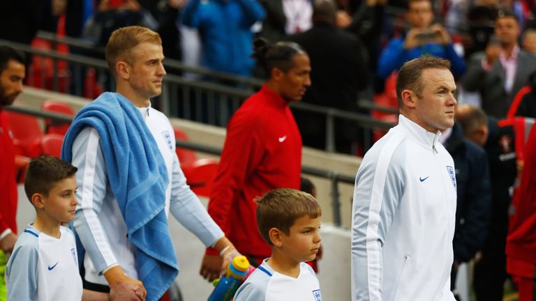Captain Wayne Rooney of England leads out the team 
