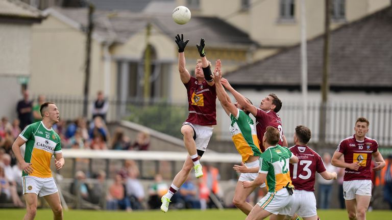 Killian Daly of Westmeath out jumps Niall Smith of Offaly and his teammate Dennis Corroon