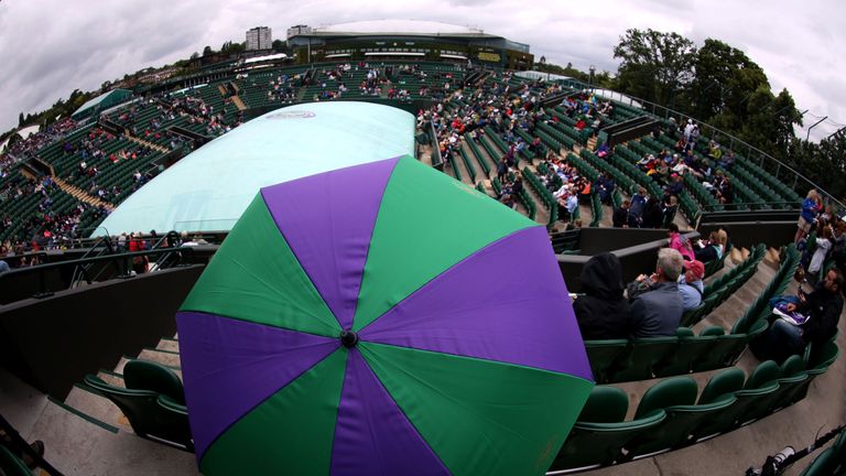 A Wimbledon umbrella on court two as rain falls on day three