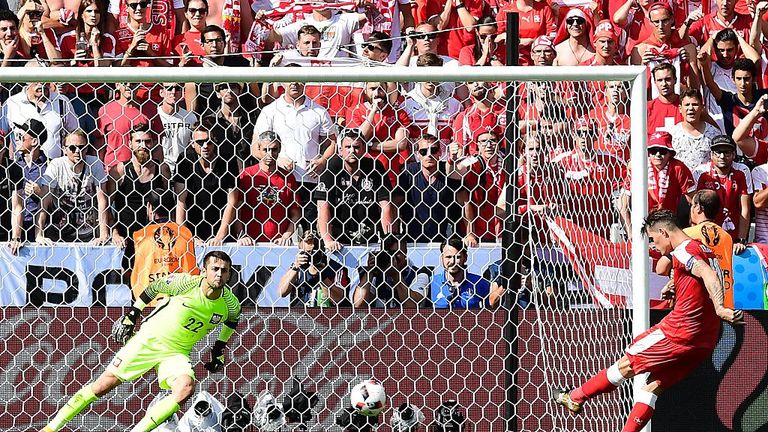 Switzerland's midfielder Granit Xhaka (R) misses his penalty attempt against Poland