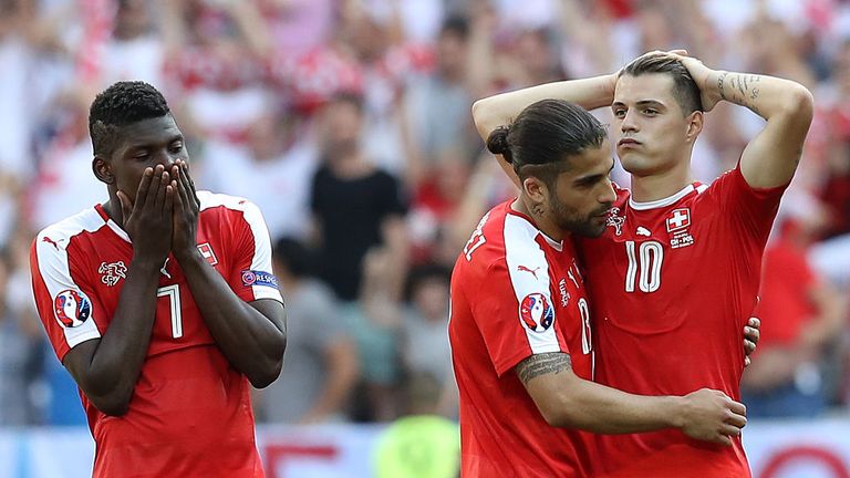 (LtoR) Switzerland's forward Breel Embolo, Switzerland's defender Ricardo Rodriguez and Switzerland's midfielder Granit Xhaka react after defeat