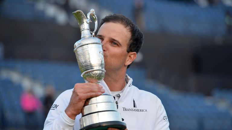 US golfer Zach Johnson kisses the Claret Jug, the trophy for the Champion golfer of the year as he poses for a photograph after winning the three-way playo