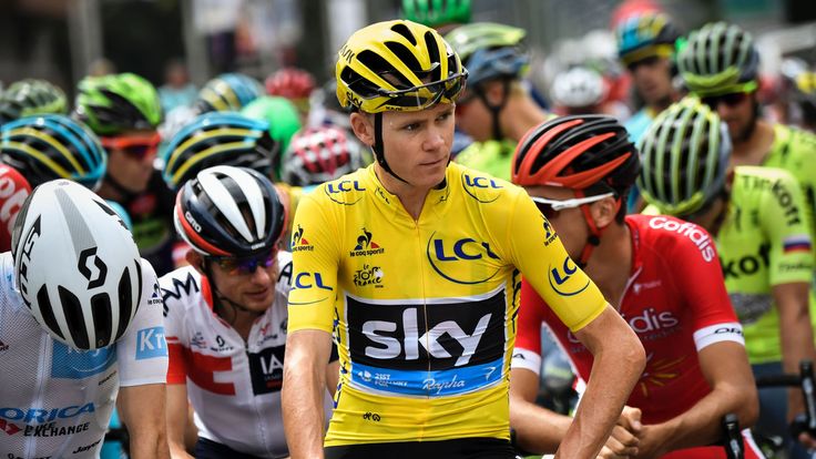 Great Britain's Christopher Froome (C), wearing the overall leader's yellow jersey, waits for the start of the 146 km nineteenth stage of the 103rd edition