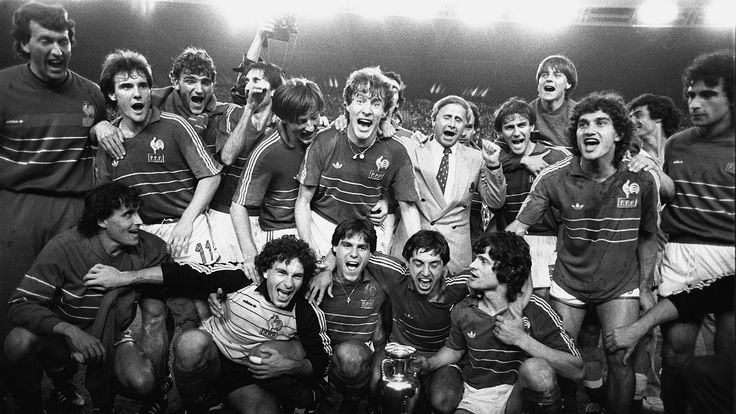 French players pose around the Cup and their coach Michel Hidalgo (with tie) after winning their first-ever European Championship