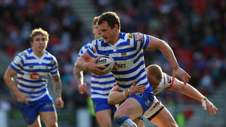 Wigan captain Sean O'Loughlin runs with the ball against St Helens