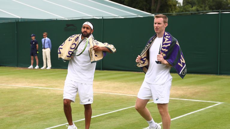 Adil Shamasdin of Canada (L) and Jonathan Marray of Great Britain (R) look on during the Men's Doubles at Wimbledon