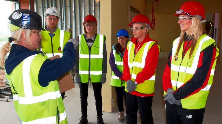 Gemma Bonner (r) and Alex Greenwood chose red hard hats for Anfield visit