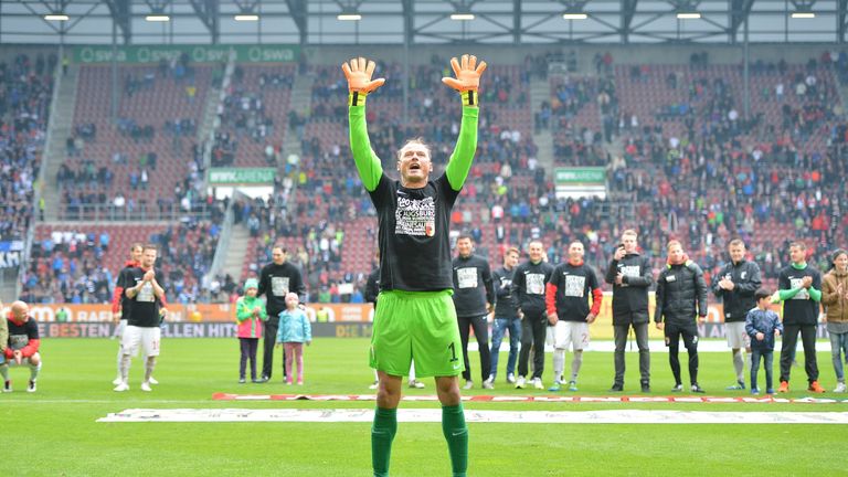 Manninger celebrates with Augsburg fans after the Bundesliga match against Hamburg in May