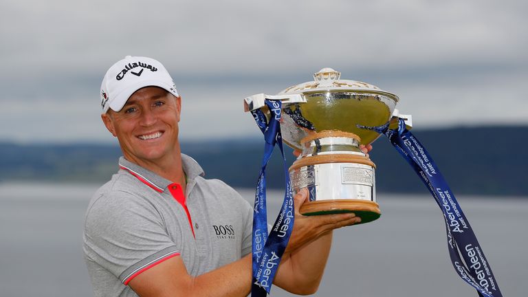 Alex Noren of Sweden poses with the trophy