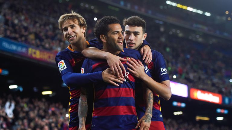 Dani Alves (C) of FC Barcelona celebrates with his teammates Sergi Samper (L) of FC Barcelona and Munir el Haddadhi of FC 