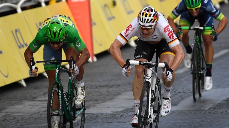 Germany's Andre Greipel (C) crosses the finish line ahead of Slovakia's Peter Sagan (L), wearing the best sprinter's green jersey at the end of the 113 km 