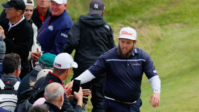 Andrew Johnston of England 'high fives' spectators on the 5th hole during the final round on day four of the 145th Open