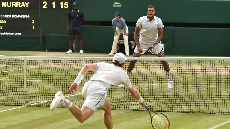 Britain's Andy Murray returns against France's Jo-Wilfried Tsonga during their men's singles quarter-final match on the tenth day of the 2016 Wimbledon Cha