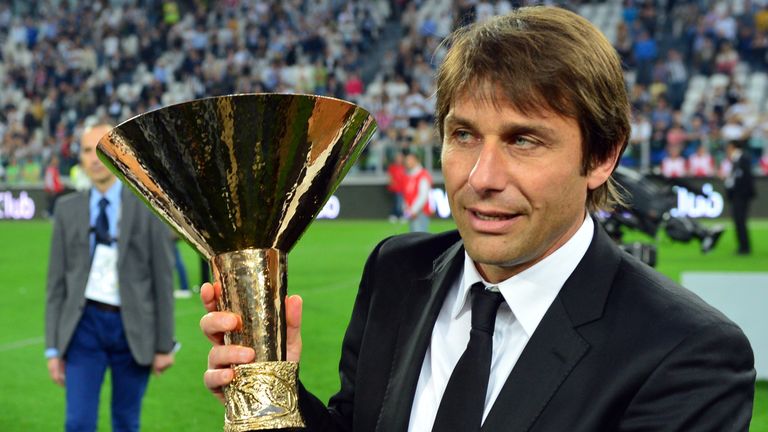 Juventus' coach Antonio Conte celebrates with the trophy during the ceremony of the Scudetto