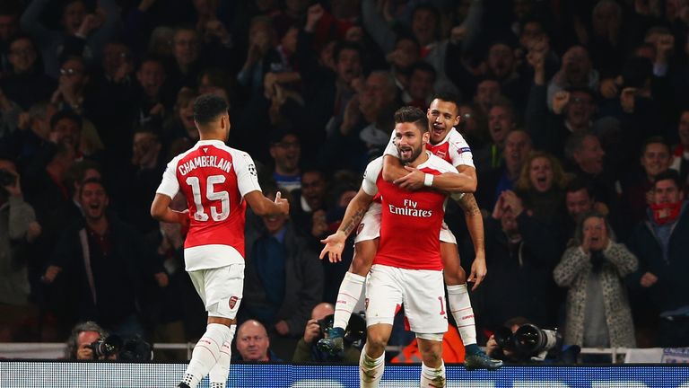 Olivier Giroud of Arsenal (C) celebrates with Alex Oxlade-Chamberlain (15) and Alexis Sanchez