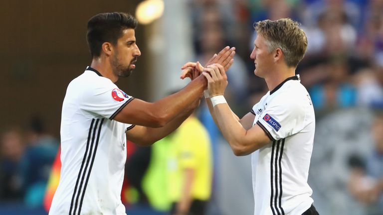 Injured Sami Khedira of Germany is replaced by Bastian Schweinsteiger (R) 