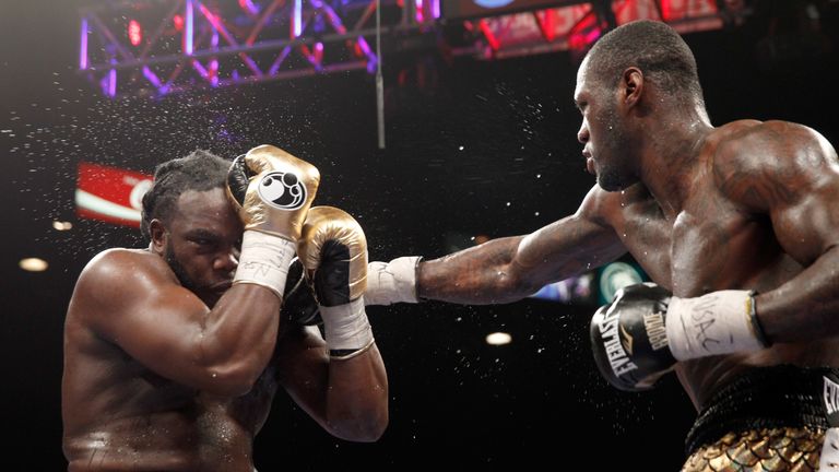 LAS VEGAS, NV - JANUARY 17:  WBC heavyweight champion Bermane Stiverne (L) takes a punch from Deontay Wilder during their title fight at the MGM Grand Gard
