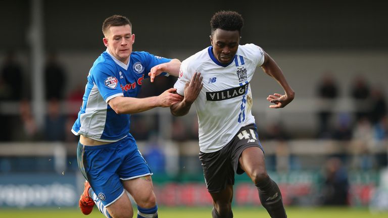 ROCHDALE, ENGLAND - DECEMBER 06:  Joe Dodoo of Bury beats Donal McDermott of Rochdale during The Emirates FA Cup Second Round match between Rochdale and Bu