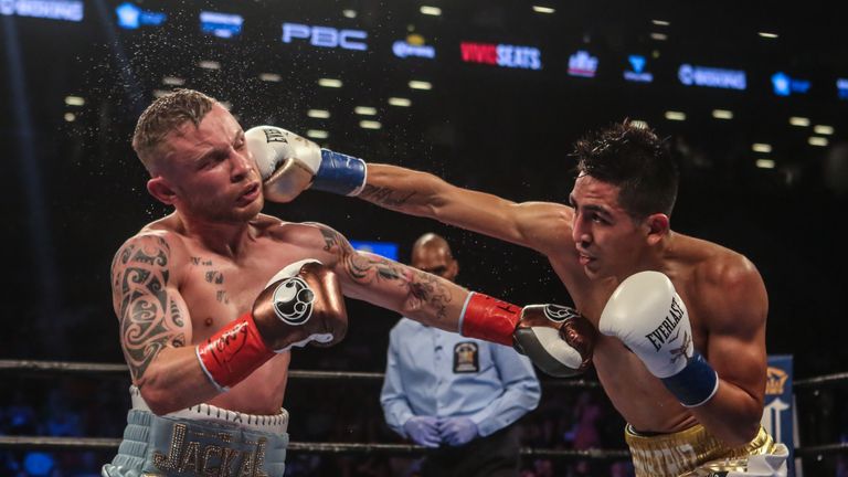 NEW YORK, NY - JULY 30:  Leo Santa Cruz of Mexico (gold trunks) fights Carl Frampton of Northern Ireland (blue trunks) during their  12 round WBA Super  fe