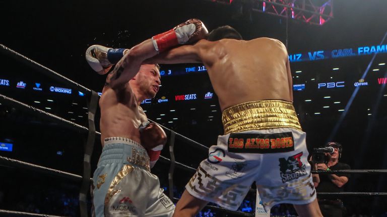 NEW YORK, NY - JULY 30: Leo Santa Cruz of Mexico (gold trunks) fights Carl Frampton of Northern Ireland (blue trunks) during their 12 round WBA Super feath