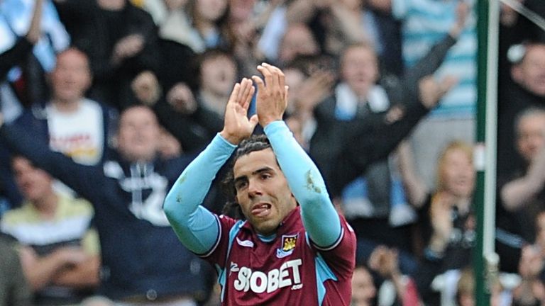 Manchester City's Carlos Tevez wears a West Ham United shirt as he leaves the field of play after the final whistle, v Man City, May 2010