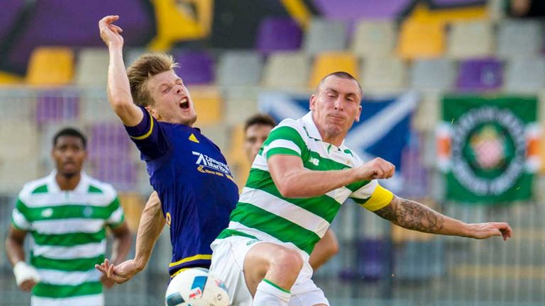 Celtic's Scott Brown (right) in typically combative mood in Maribor