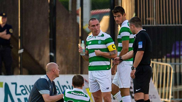 Celtic's Stefan Johansen (grounded) gets treatment as Scott Brown looks on.