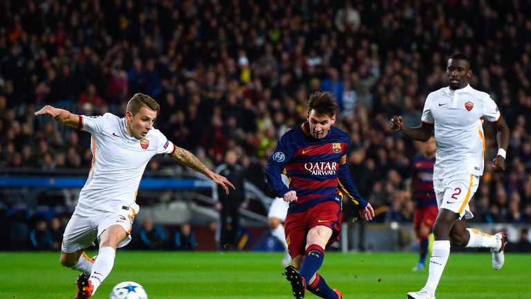 BARCELONA, SPAIN - NOVEMBER 24:  Lionel Messi of FC Barcelona shoots towards goal under a challenge by Lucas Digne of AS Roma during the UEFA Champions Lea