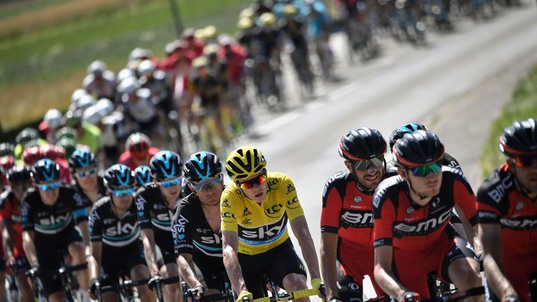 Great Britain's Christopher Froome (C), wearing the overall leader's yellow jersey, rides in the pack during the 209 km sixteenth stage of the 103rd editio