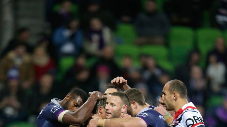 Storm players celebrates a try scored by Cooper Cronk during the round 20 NRL match between the Melbourne Storm and the Sydney Roosters