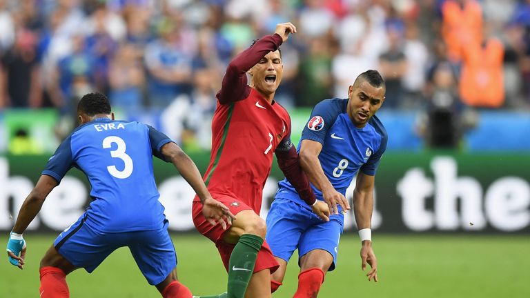 Cristiano Ronaldo (C) of Portugal was hurt after a challenge by France's Dimitri Payet (R) during the Euro 2016 final