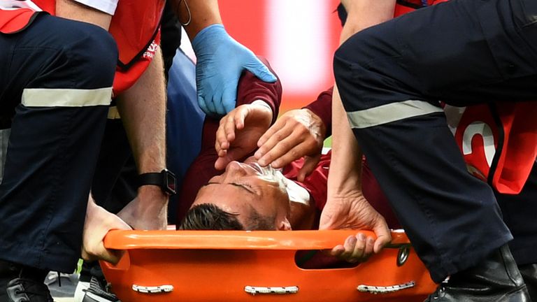 Cristiano Ronaldo of Portugal shows his emotion in the stretcher before being taken off the pitch during the UEFA EURO 2016 Final 