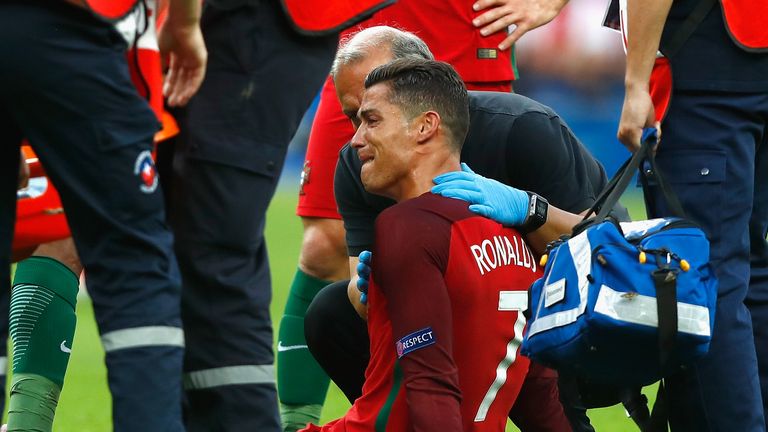 Cristiano Ronaldo is consoled after picking up an injury that forced him off in the first half of the Euro 2016 final