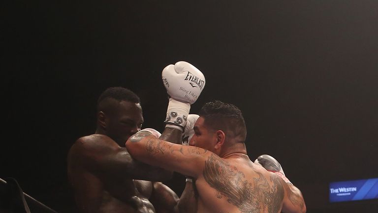 Chris Arreola tries to rough Deontay Wilder up on the ropes