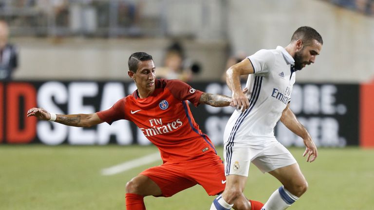 Paris Saint-Germain midfielder Angel Di Maria (L) tries to steal the ball from Real Madrid defender Daniel Carvajal (R) 
