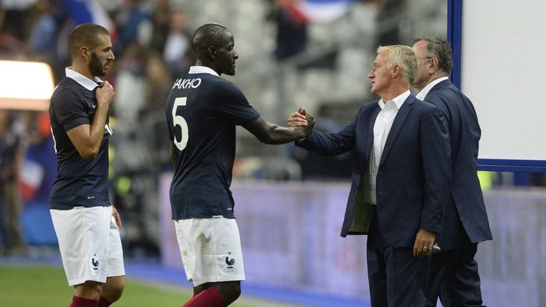 France's head coach Didier Deschamps (R) shakes hands with France's defender Mamadou Sakho after the friendly football match France vs Spain, on September 