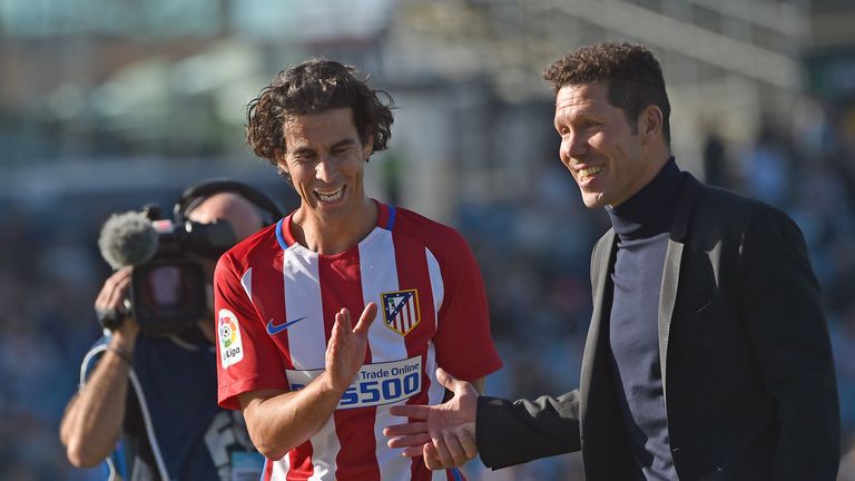 Atletico's coach Diego Simeone (R) and player Tiago Mendes (L) react during the friendly football match between Spanish side Atletico Madrid and Australian