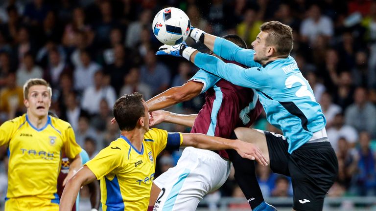 Winston Reid (L) of West Ham is fouled by goalkeeper Axel Maraval (R) of Domzale during the UEFA Europa League third qualifying round.