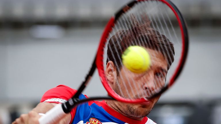 Dusan Lajovic of Serbia returns the ball to James Ward of Great Britain during the Davis Cup Quarter Final match July 2016