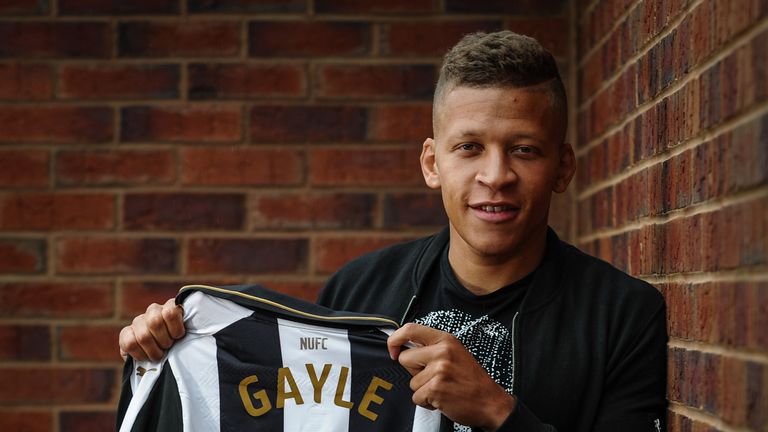 New signing Dwight Gale poses for a photograph holding a named shirt at The Newcastle United Training Centre