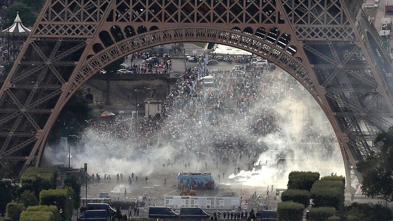 TOPSHOT - A picture taken from the Tour Montparnasse shows tear gas under the Eiffel tower during clashes between police and supporters trying to illegally