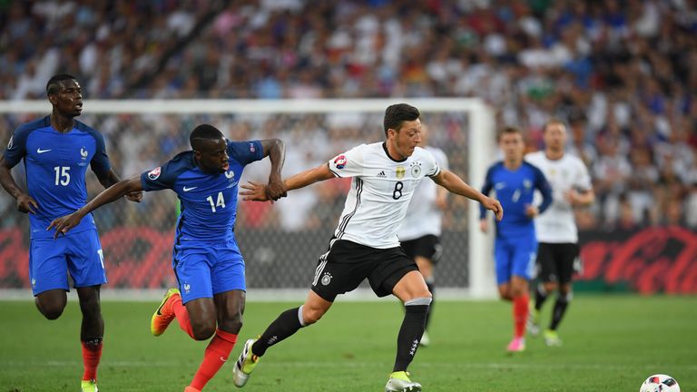 Mesut Oezil of Germany runs with the ball under pressure from Blaise Matuidi of France during the UEFA EURO semi final match 