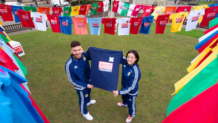 Scotland's Robert Snodgrass and Gemma Fay promote the nations taking part in the Homeless World Cup earlier this year. 